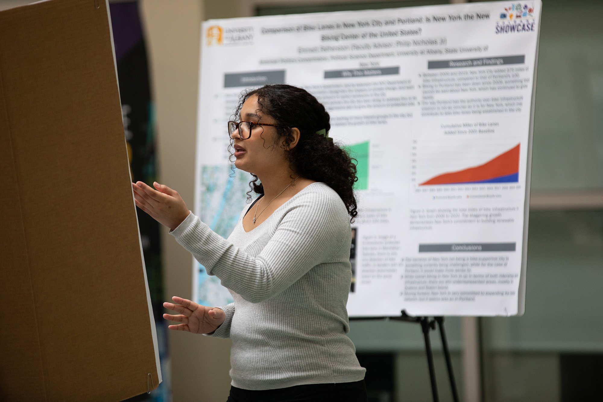 A student discusses her poster during Showcase Day 2024.