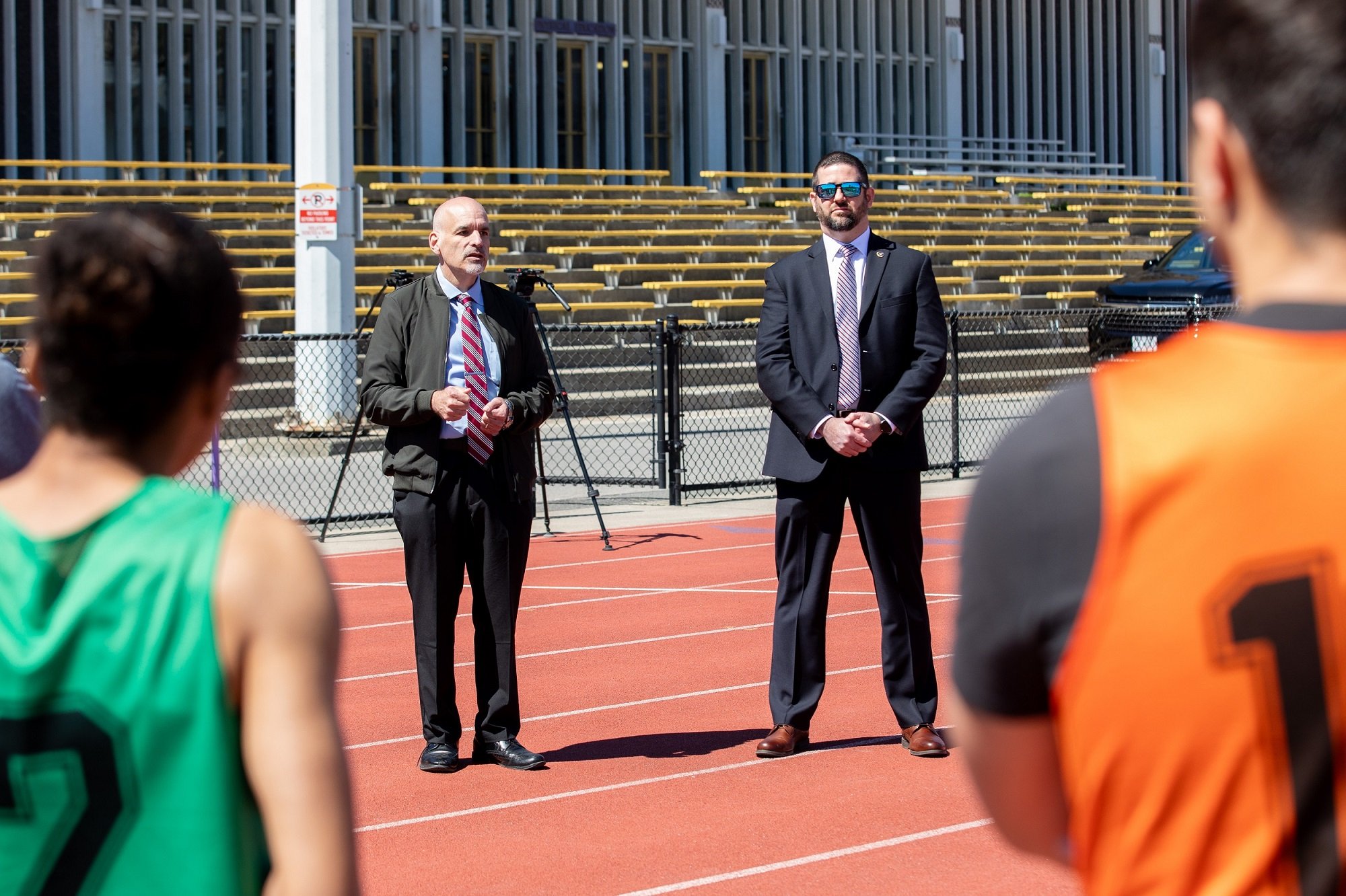 CEHC Dean Robert Griffin and Tremaroli, special agent in charge of the FBI Albany Field Office, talk with students before the start of the physical fitness test at UAlbany.