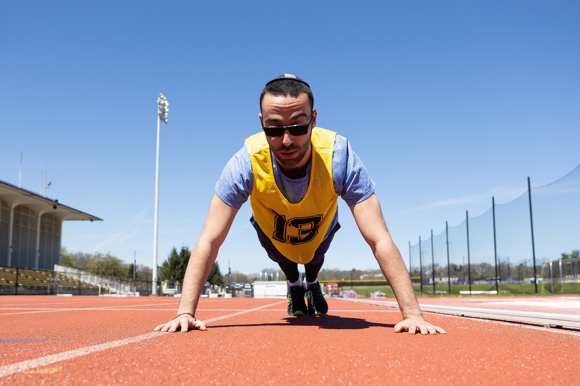 A student prepares for a push up during the physical fitness test at UAlbany.
