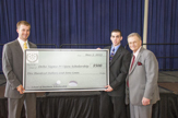 Delta Sigma Pi President Colin Gerner and Assistant Dean John Levato award DSP Open scholarship check to James Schiaffo 