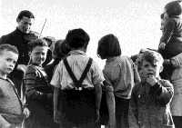 Violinist plays for children at Westerbork. From 'Images: Camp Orchestras' at http://fcit.coedu.usf.edu/holocaust/resource/gallery/CampOrch.htm