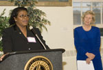 Dean Katharine Briar-Lawson (R.) looks on as Betty Barnette, chair of the school’s advisory committee, congratulates the school on its 40th anniversary.