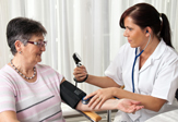 A nurse takes a patient's blood pressure.