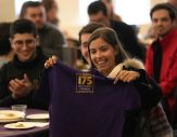 IBS student holds up a UAlbany T-shirt.