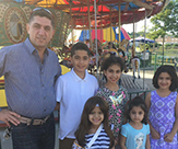 Pictured: Zeyad Alsaadi, an Iraqi refugee, standing with his five children. 