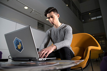 UAlbany senior Aleks Siemenn views his climate modeling on a laptop in University Hall.