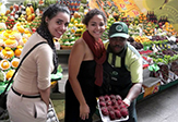 UAlbany students Alana Biegelson and Roely Castro with a fruit vendor in Brazil.