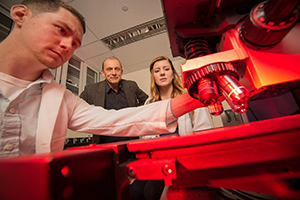 UAlbany Chemistry Professor Igor Lednev works with Ph.D. candidates Claire Muro and Kyle Doty.
