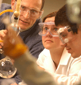 students and professor with lab equipment