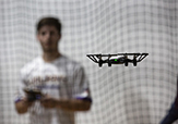 A studnet lauches a drone in the new testing lab in the basement of Page Hall.