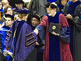 Interim President James Stellar congratulates a graduate.