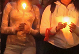 Two girls hold vigil candles over the Parkland shooting