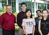 Tom Begley stands with four of the newest RNA Fellows