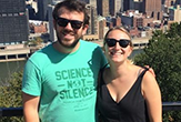 Kyle Bucklin and Elena Brondolo, students who fnished their MBAs while traveling cross country, stand overlooking the Pittsburgh skyline.
