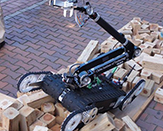 robot climbing over pieces of wood