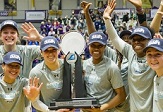 UAlbany women's basketball team with America East trophy.