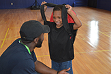 Psychology student speaking with a young boy at the Schenectady Boys & Girls Club.