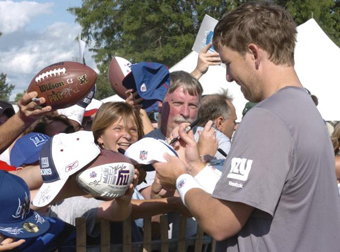 Two-time Super Bowl MVP Eli Manning signs autographs for Giants fans at the University at Albany