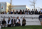 students pose in front of the FBI building, Albany