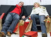 Holiday Shoppers Take a Break on a Sofa