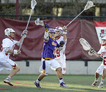 UAlbany's Miles Thompson battles with Denver for the ball