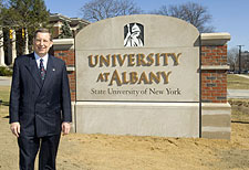 President Hall unveils new sign for the downtown campus.