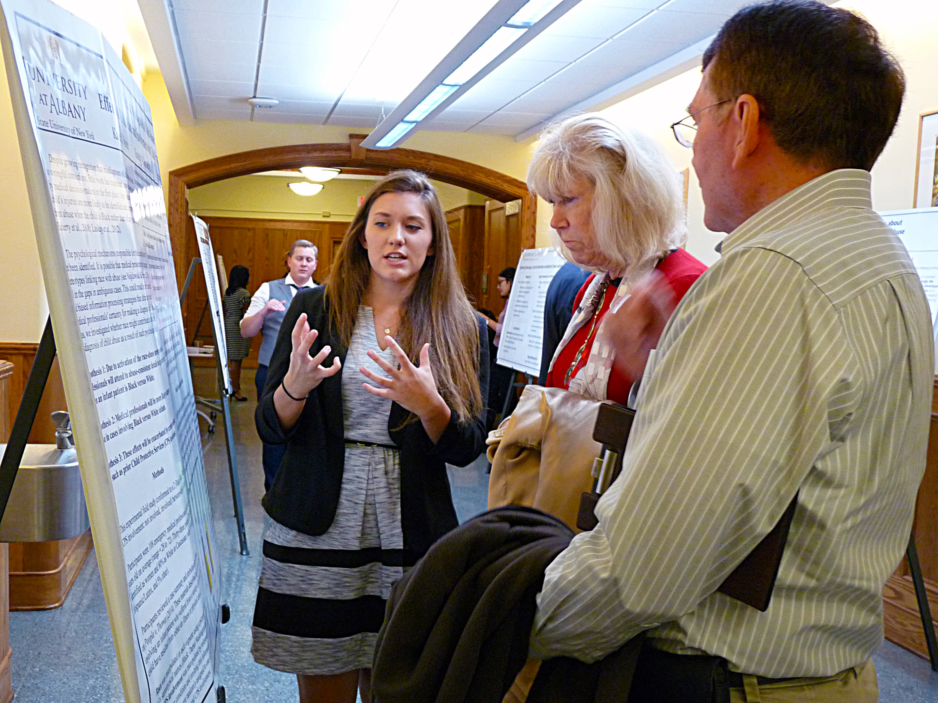 A criminal justice student explains her research during a poster session