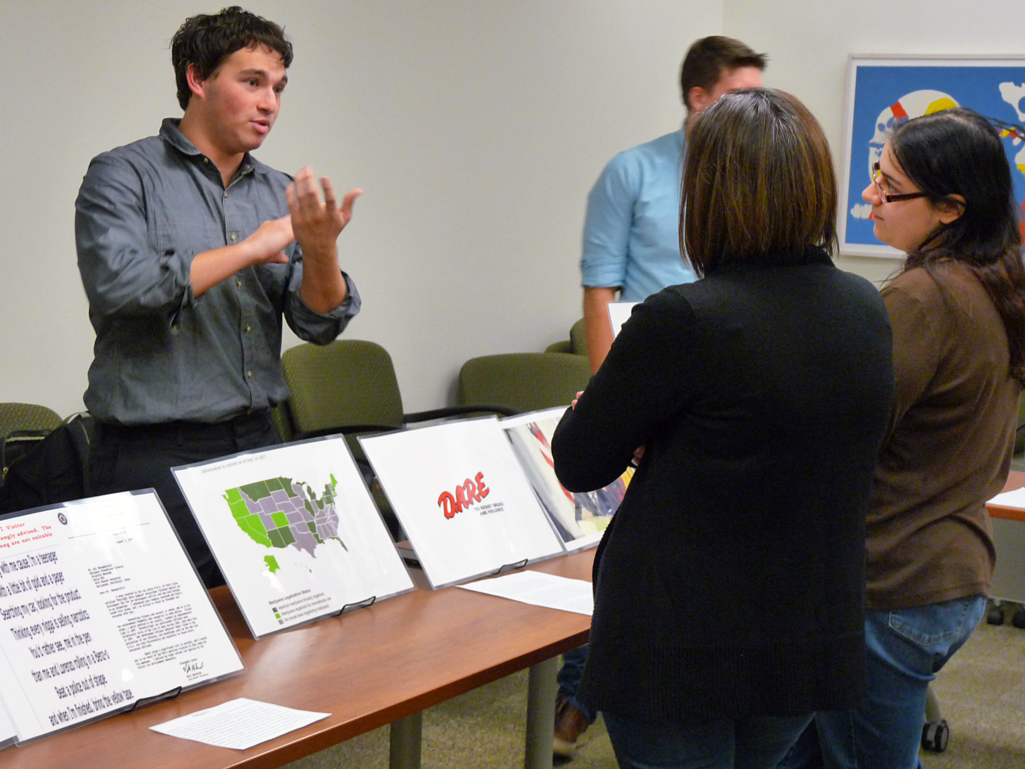 A student discusses his criminal justice research with community members