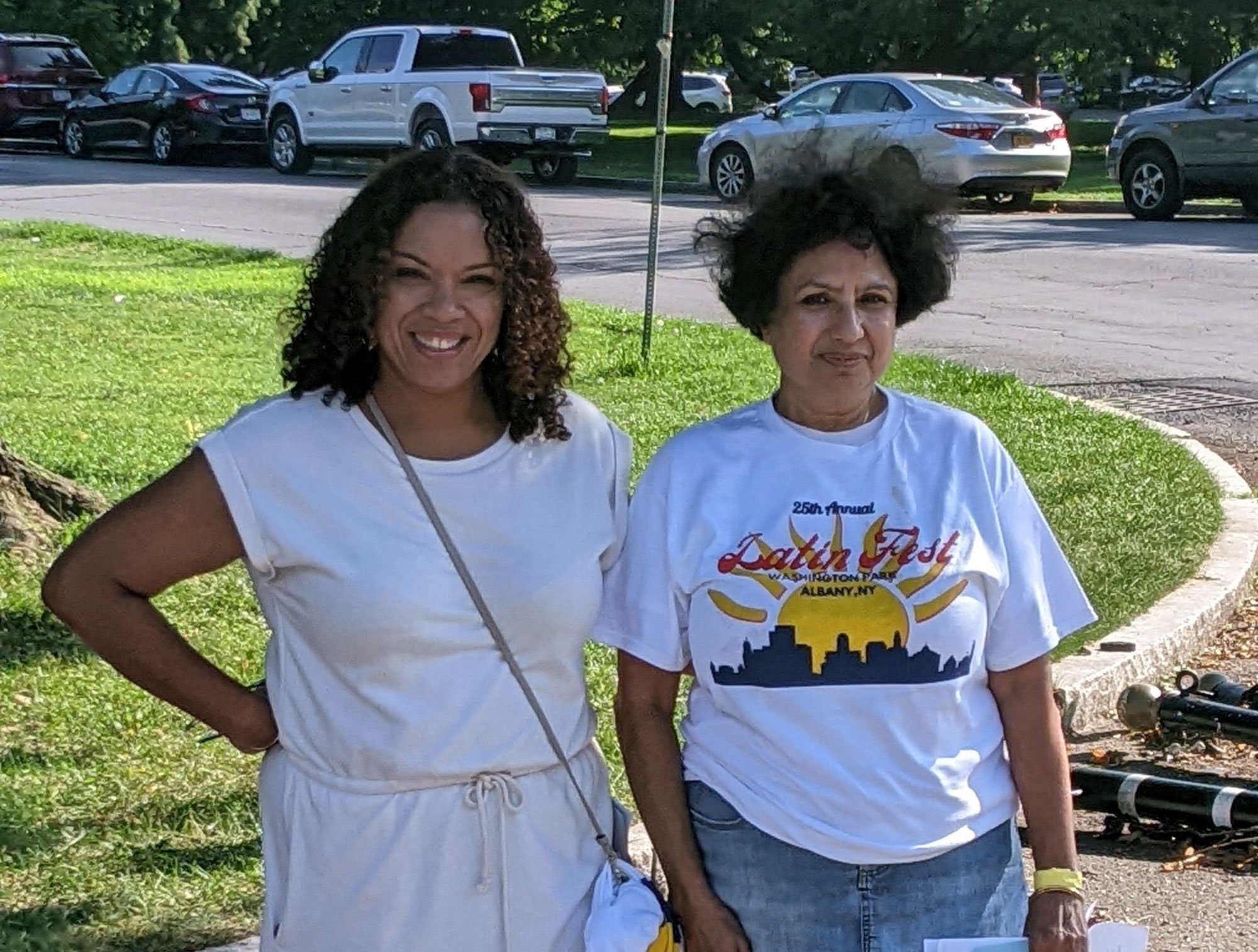 Two women, one wearing a 2022 LatinFest t-shirt, pose for a photo.