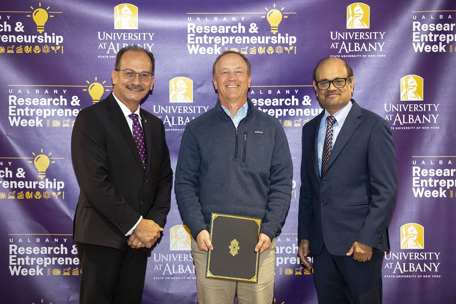 J. Andrew Bergland, The RNA Institute, with UAlbany President Havidán Rodríguez and Vice President for Research and Economic Development Thenkurussi “Kesh” Kesavadas.