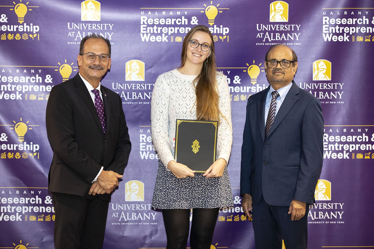 Hannah Shorrock, The RNA Institute, with UAlbany President Havidán Rodríguez and Vice President for Research and Economic Development Thenkurussi “Kesh” Kesavadas.
