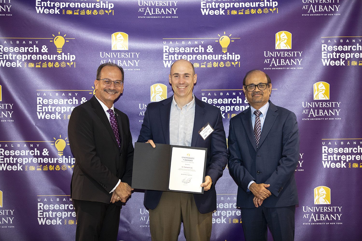 Nathaniel Cady, CNSE, with UAlbany President Havidán Rodríguez and Vice President for Research and Economic Development Thenkurussi “Kesh” Kesavadas.