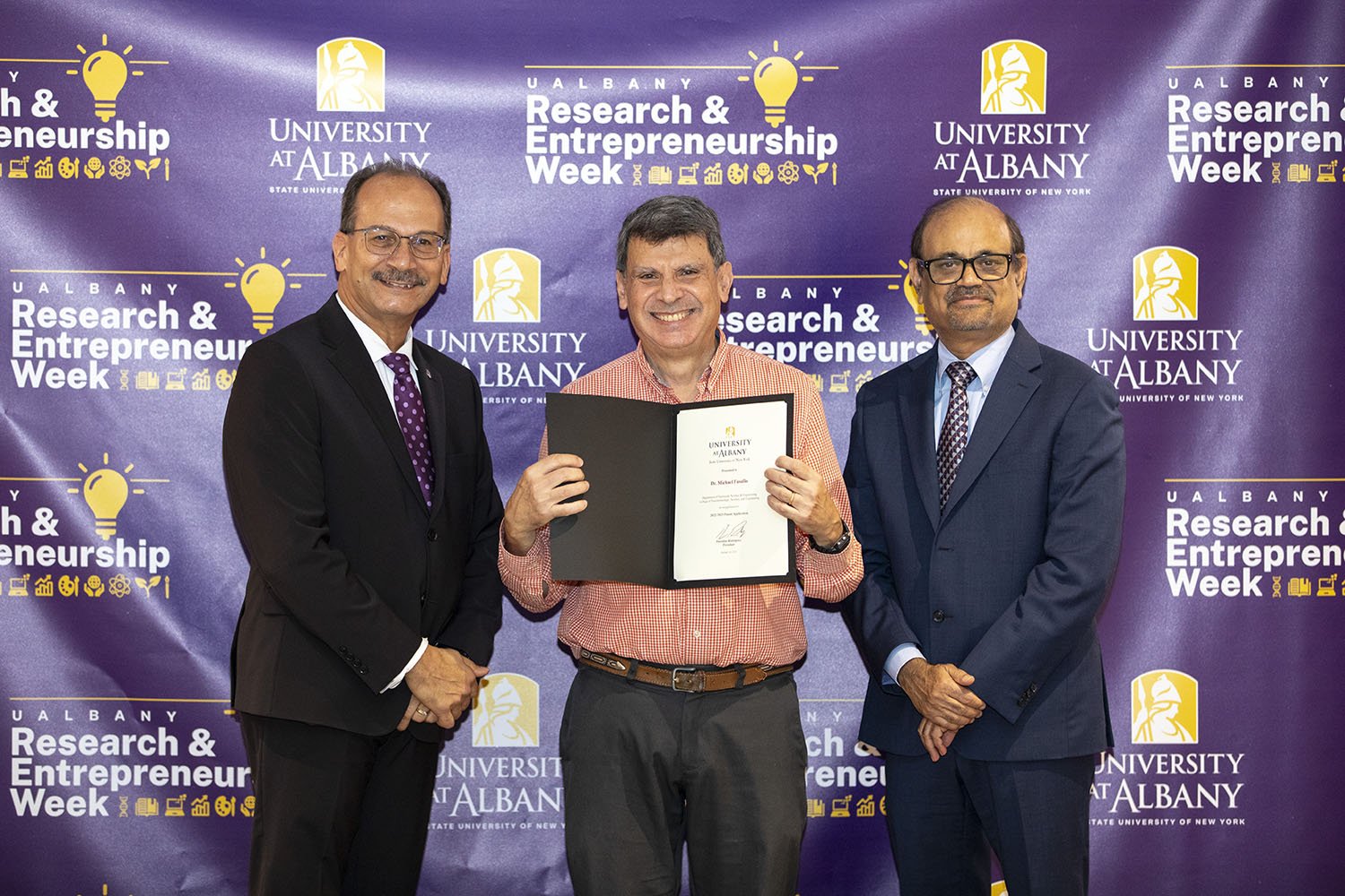 Michael Fasullo, CNSE, with UAlbany President Havidán Rodríguez and Vice President for Research and Economic Development Thenkurussi “Kesh” Kesavadas.