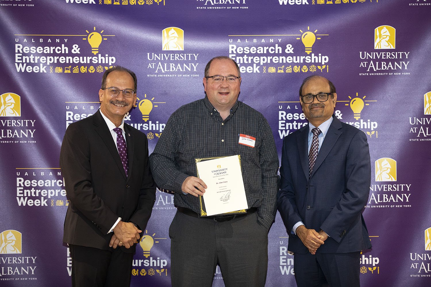 John Cleary, The RNA Institute, with UAlbany President Havidán Rodríguez and Vice President for Research and Economic Development Thenkurussi “Kesh” Kesavadas.