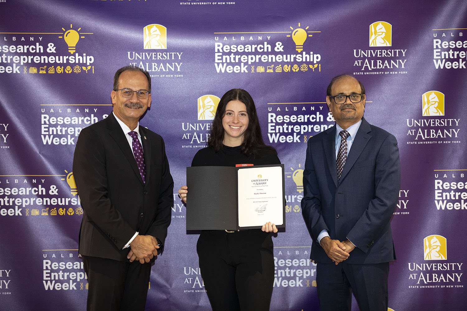 Hayley Peterson, CEHC, with UAlbany President Havidán Rodríguez and Vice President for Research and Economic Development Thenkurussi “Kesh” Kesavadas.