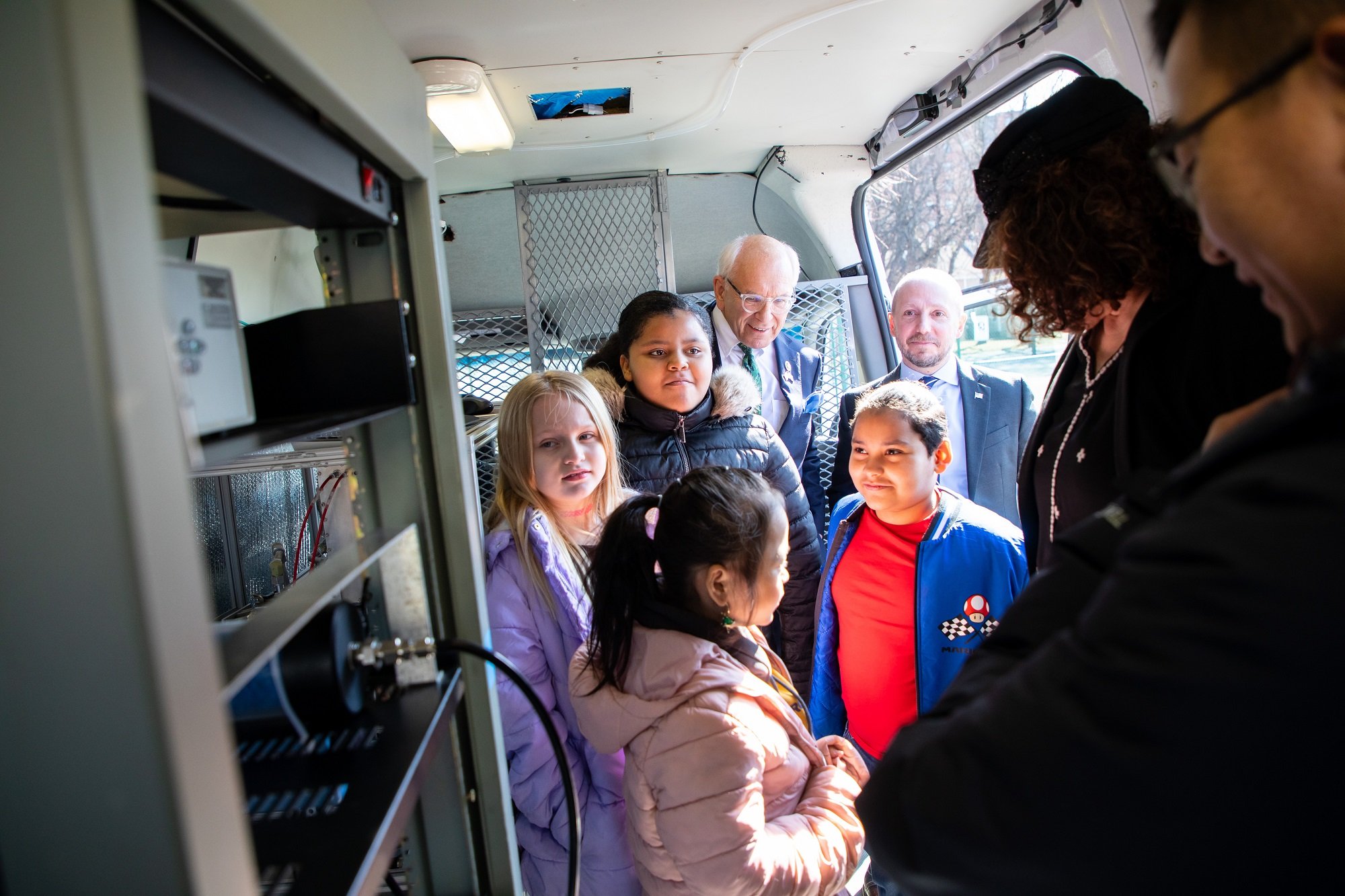 Students at the Giffen Memorial Elementary School stand inside UAlbany's mobile laboratory with Congressman Tonko.