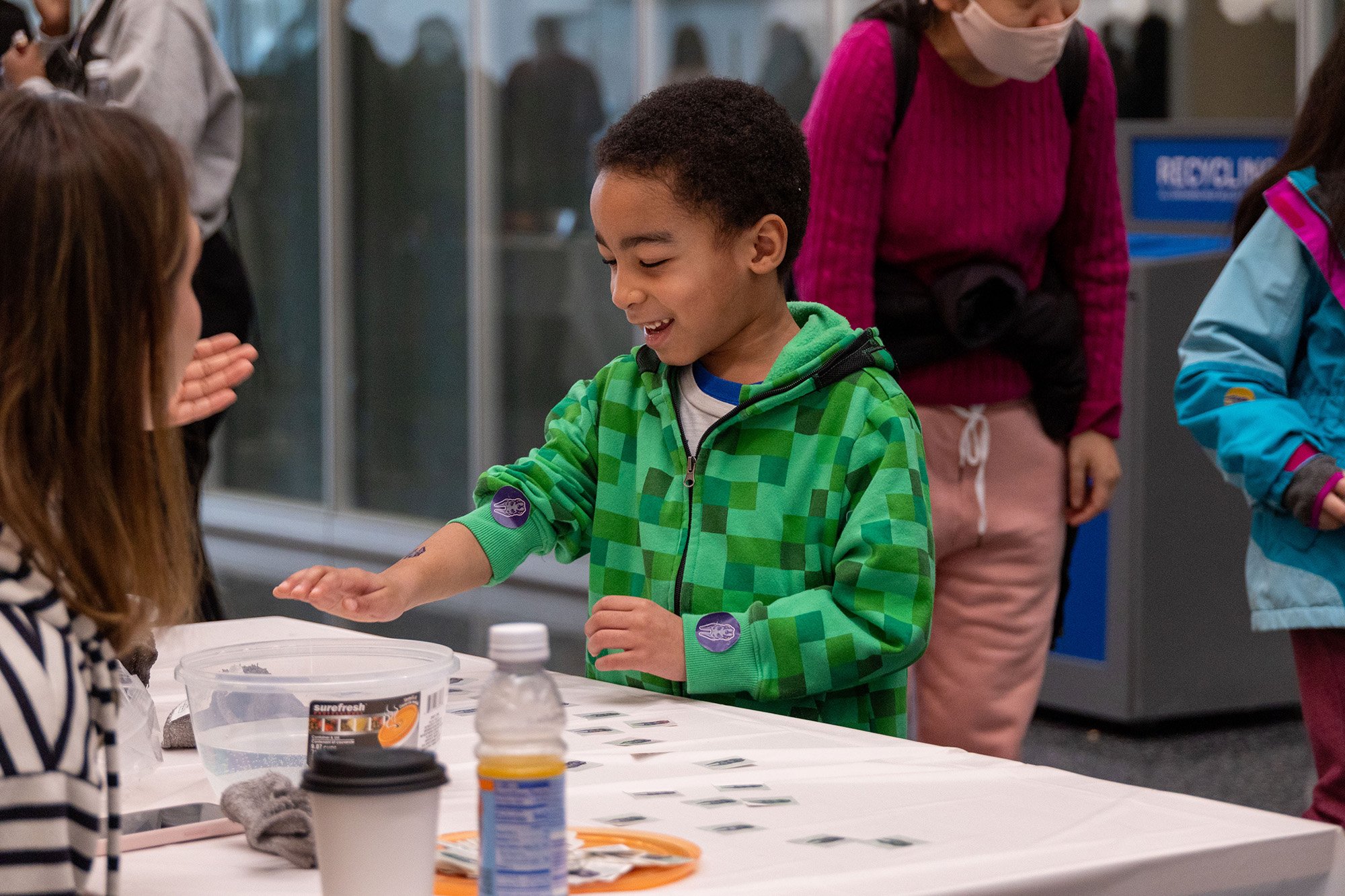 A young boy takes part in a table-top experiment at UAlbany's STEM & Nanotechnology Family Day at ETEC.