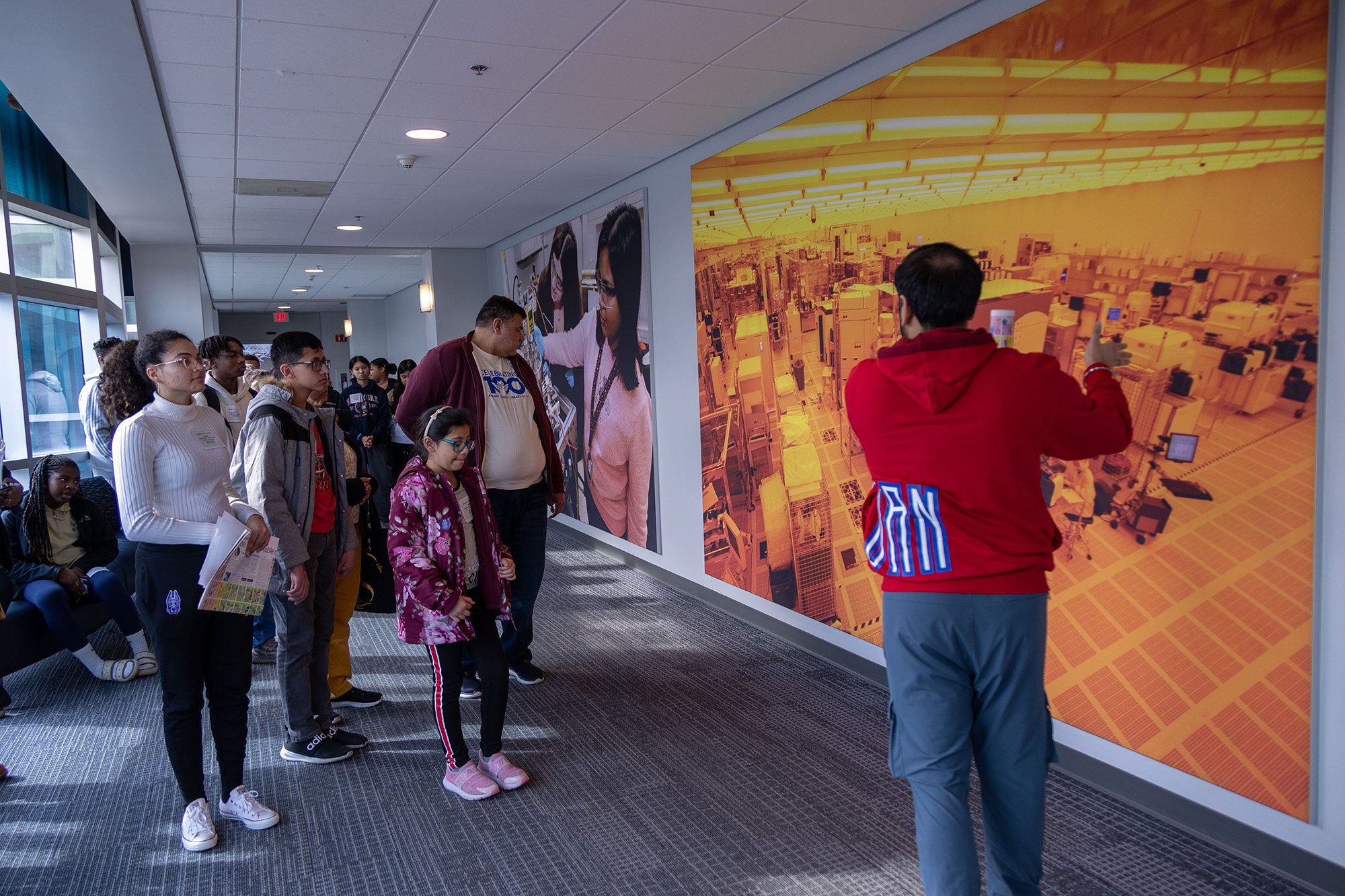 Members of the Capital Region community view a picture of a clean room at UAlbany's STEM & Nanotechnology Family Day at NY CREATES' Albany NanoTech Complex.