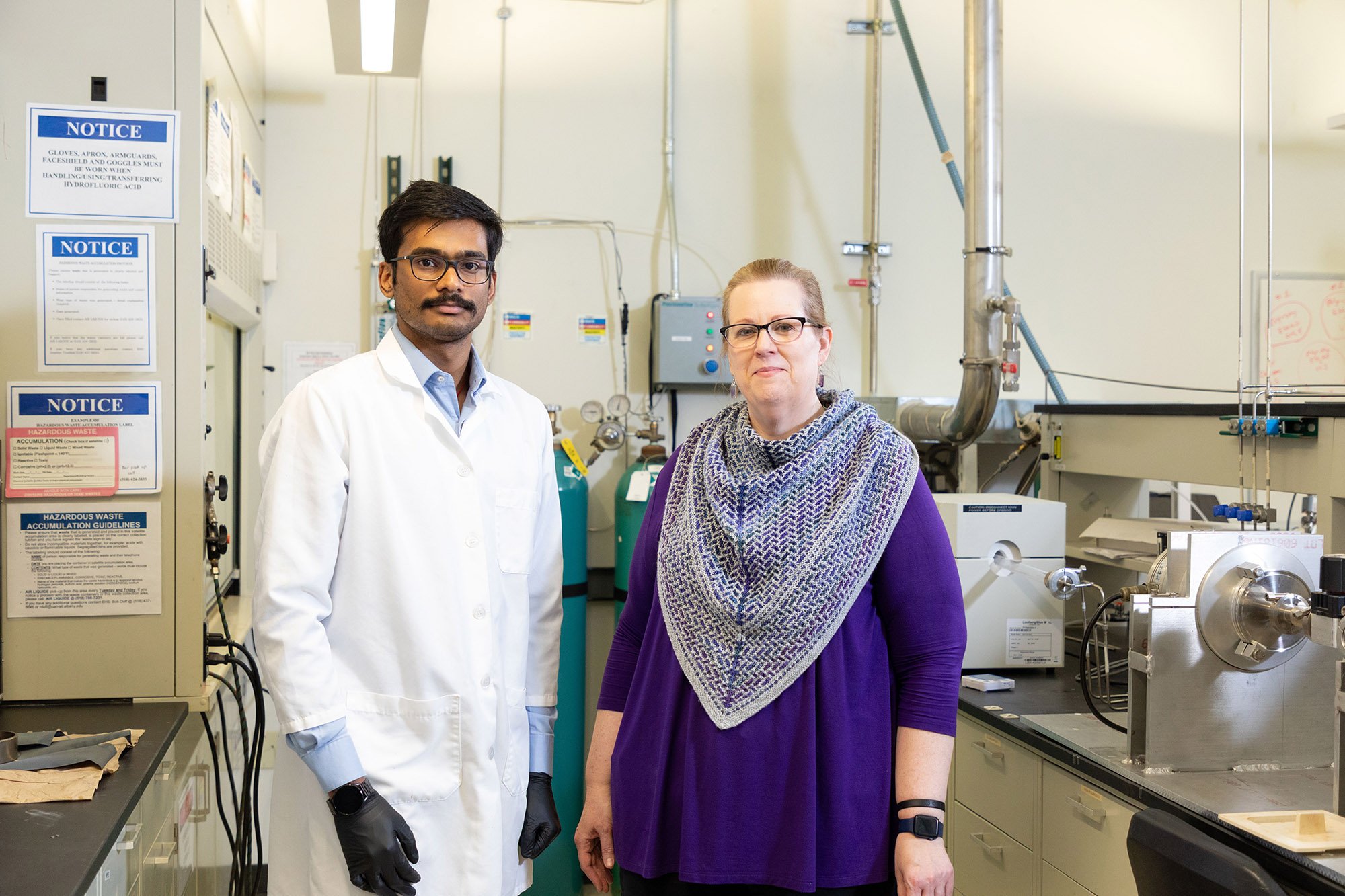 Nanoscale PhD Student Sri Saravana Konganapuram Narasimma Bharathi and Professor Kathleen Dunn stand smiling inside Professor Dunn's lab.