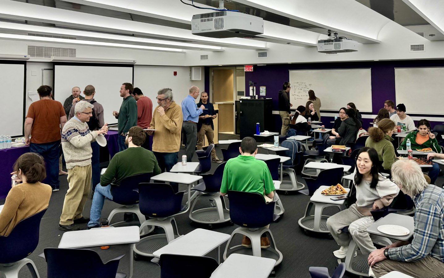Faculty and staff from UAlbany's Department of Mathematics and Statstics celebrates Pi Day on March 14 with pizza.