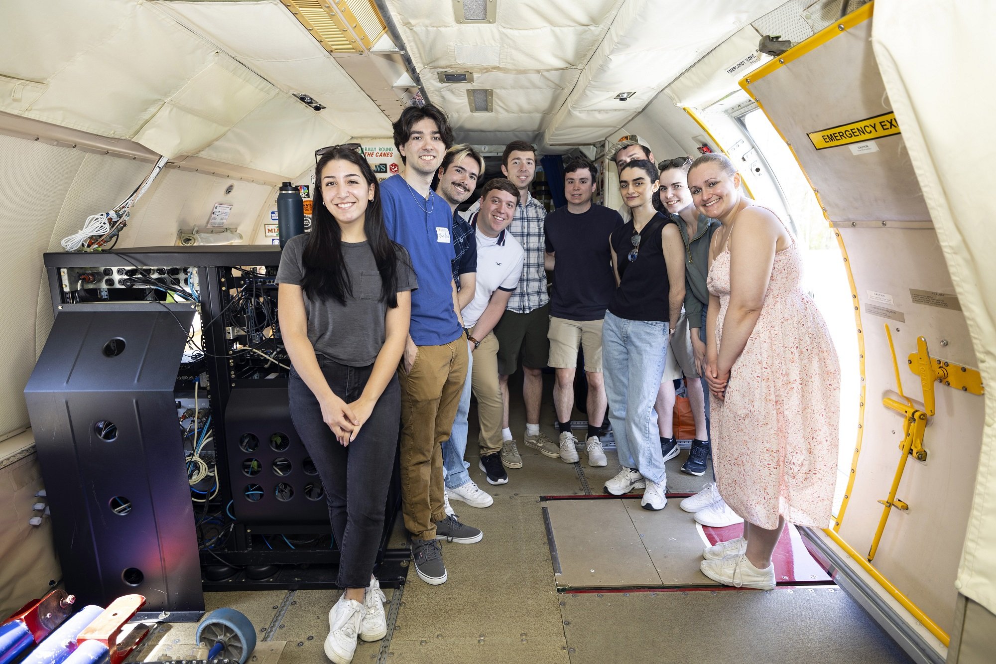 UAlbany students stand together for a photo inside the NOAA Hurricane Hunter.