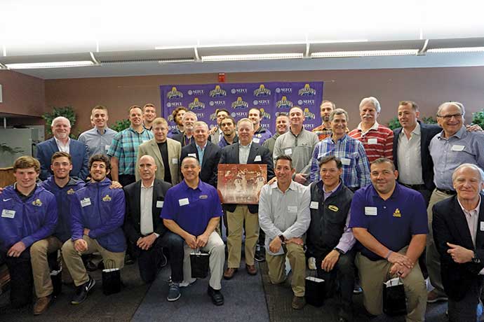 UAlbany men's lacrosse team and coaches pose for photo