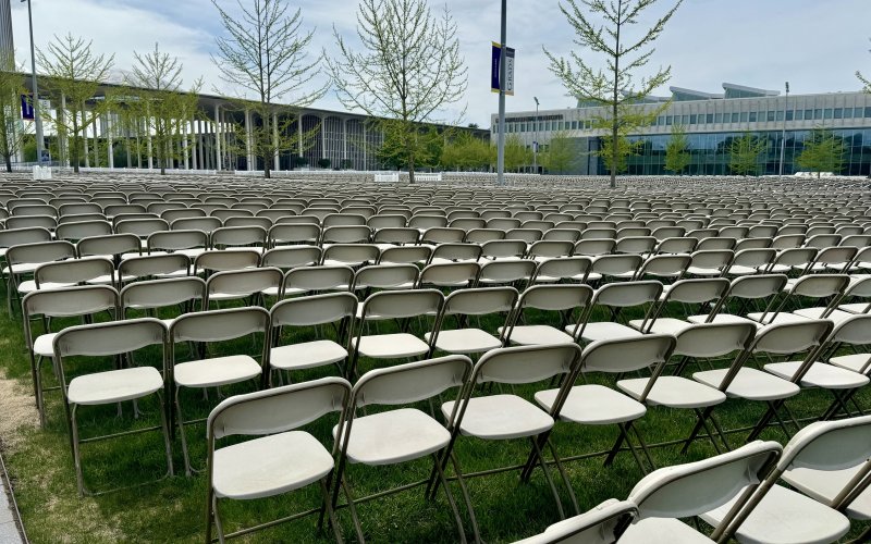 Rows of chairs are lined up in the entry plaza of the Uptown Campus for the 2024 undergraduate commencement ceremony.