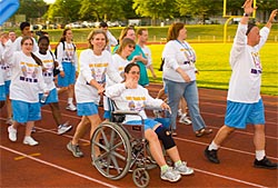 Special Olympics athletes parade by the stands