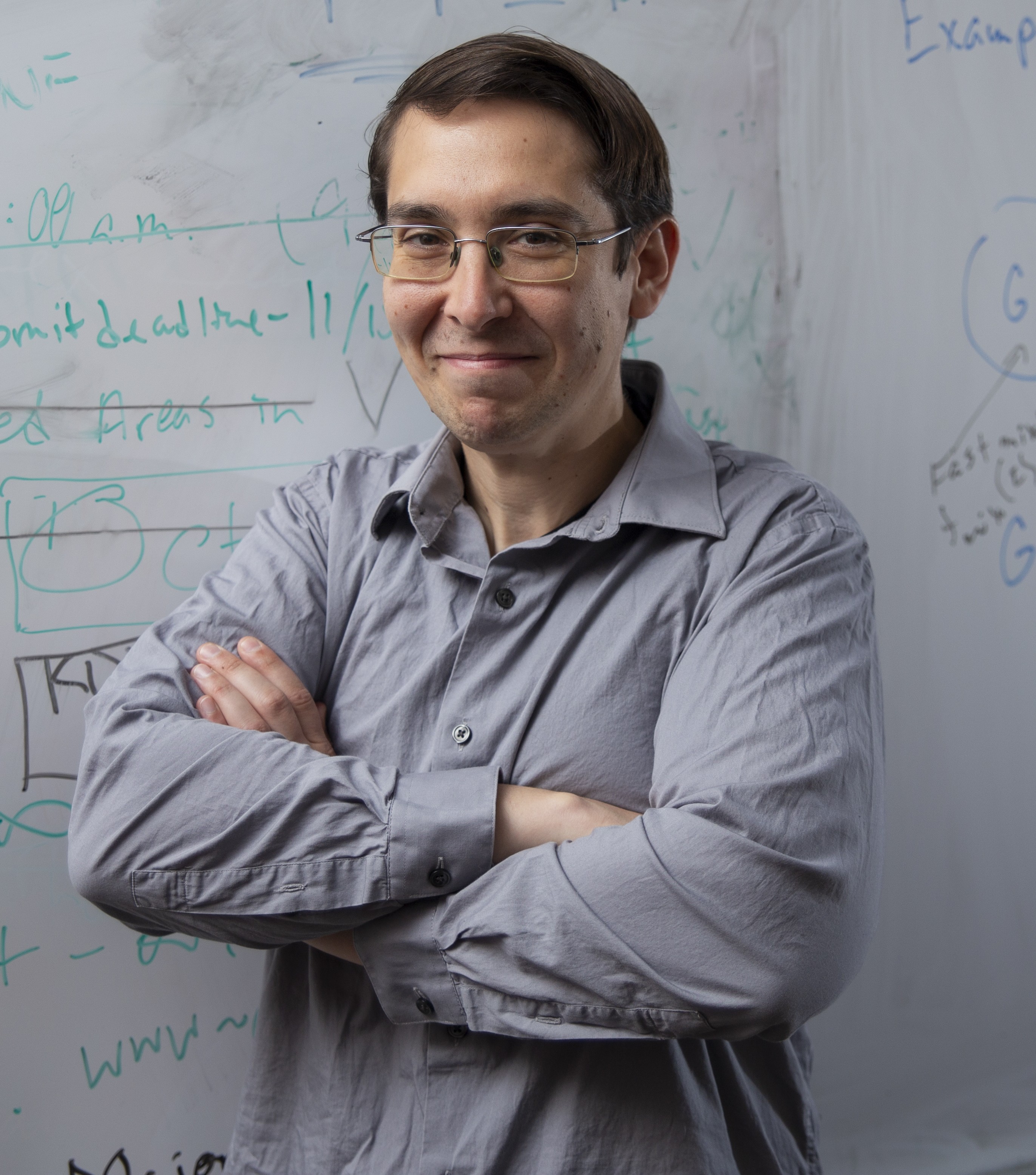 An image of Abram Magner in front of a whiteboard.