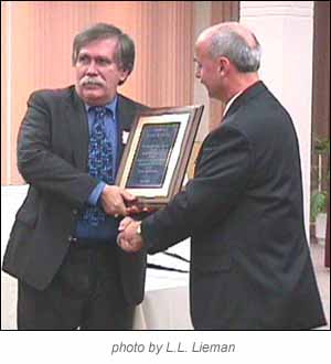 Tom Gebhardt presents an award to Henry M. Madej