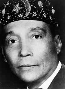 Elijah Muhammad, in a classic pose.