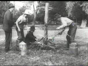 Placing kindling around the lynching posts used for the Landry family.