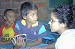 Aleidy Diaz playing Uno with some boys.