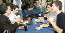 Anthropologist David Strait speaks with three of his "human evolution" students in the Indian Quad cafeteria.